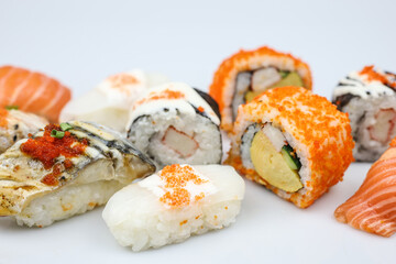 Sushi rolls japanese food isolated on white background. California Sushi roll with tuna, vegetables and unagi sauce closeup. Japan restaurant menu.
