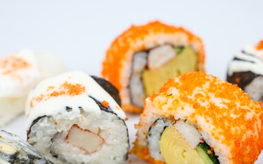 Sushi rolls japanese food isolated on white background. California Sushi roll with tuna, vegetables and unagi sauce closeup. Japan restaurant menu.
