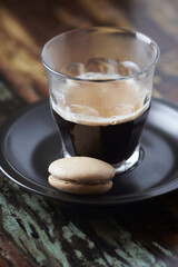Coffee in glass cup on rustic wooden background. Close up.	