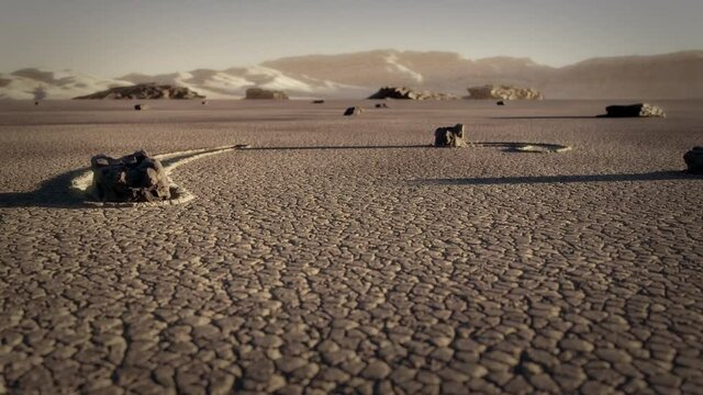 Desert sailing stones moving under rising sunlight revealing a smile drawn in the sand by the tracks - 3d Abstract scene ground level to top view Reveal shot