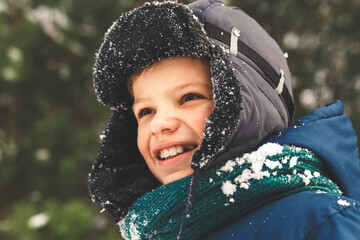 Portrait of a boy in a winter hat in nature winter th in the park
