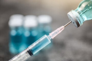 Close up vaccine vial dose flu shot drug needle syringe, medical concept vaccination hypodermic...