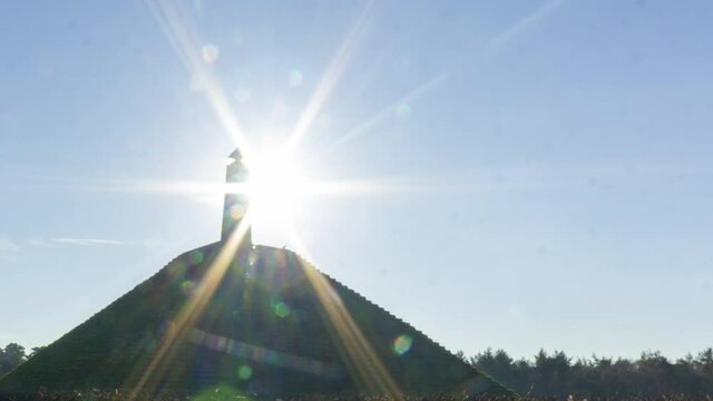 panning Time lapse of sun appearing behind obelisk on Austerlitz Piramid. The Piramide van Austerlitz is a monument built in 1804 as a tribute to Napoleon Bonaparte.