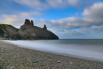 Stunning long exposure low ground view of seascape and Black Castle ruins along Wicklow coastal...