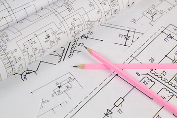 Work of an electronic engineer. Electrical engineering drawings and pencils.