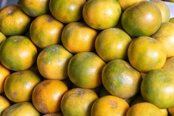 Fresh tangerines on traditional market as background