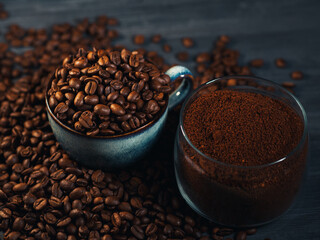 A cup of roasted beans and a bowl of ground coffee