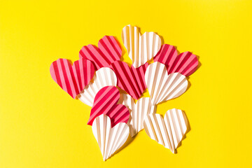 Valentine's day flat lay with copy space. Pink and white hearts on the yellow background. Image for greeting cards. Valentine's day concept	
