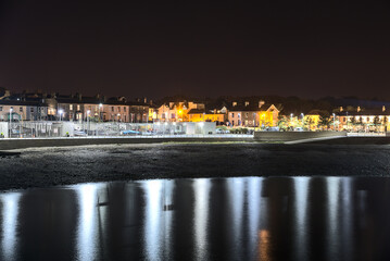 Obraz premium Beautiful night view of Greystones Harbour Marina with light reflection in the water, Greystones, Co. Wicklow, Ireland