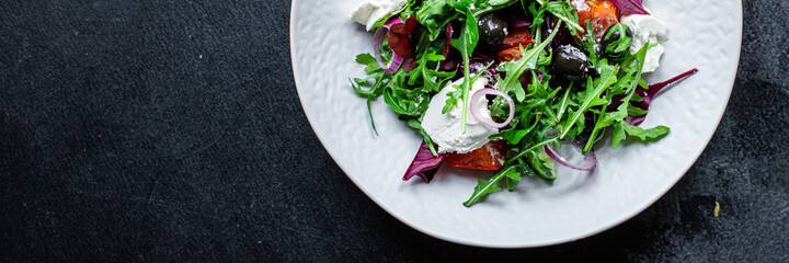 Greek salad vegetables and feta cheese portion on the table for healthy meal snack outdoor top view copy space for text food background rustic image keto or paleo diet
