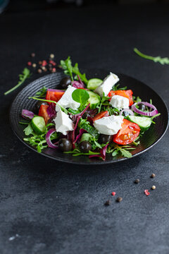 Greek salad vegetables and feta cheese portion on the table for healthy meal snack outdoor top view copy space for text food background rustic image keto or paleo diet