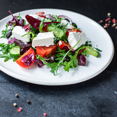 Greek salad vegetables and feta cheese portion on the table for healthy meal snack outdoor top view copy space for text food background rustic image keto or paleo diet