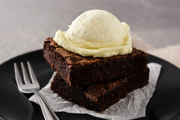 Brownie with vanilla ice cream scoop on gray scoop