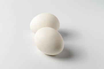 Still life with two chicken eggs on a white background