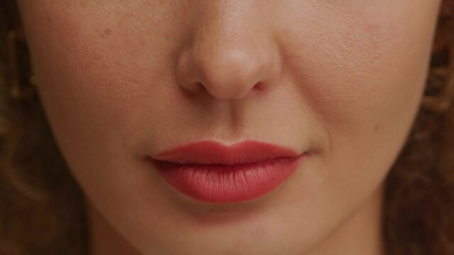 Woman lips closeup moving in a sexy manner