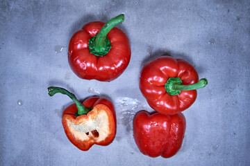 Red bell peppers on wooden background from the top angle. 