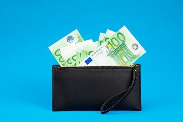 20, 50, 100, 200 Euro banknotes in a black leather wallet close-up. The concept of cash, cash savings, prosperity. Euromoney