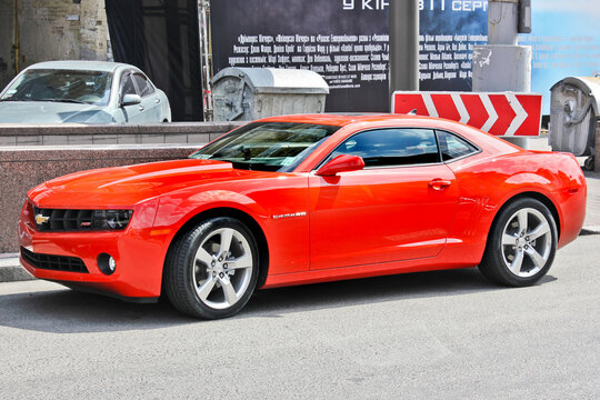 Kiev, Ukraine - August 14, 2011: Red American muscle car Chevrolet Camaro parked in the city