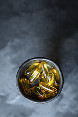 fish fat pills capsules vitamins omega 3 or hyaluronic acid dietary supplement for cosmetic purposes or strengthening the body's immunity ready to eat on the table for healthy background copy space