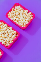 Minimal popcorn set plastic box on purple background. Isometry trendy vertical design. Fast food, Home cinema concept