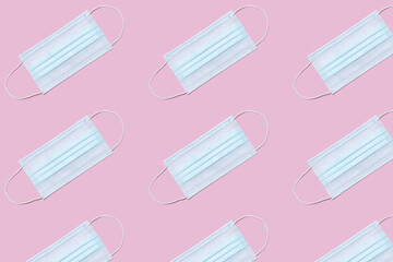 Medical protective masks on a pink background. Texture for design.