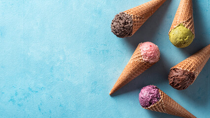 Various ice cream scoops in cones with copy space. Colorful ice cream in cones chocolate,...
