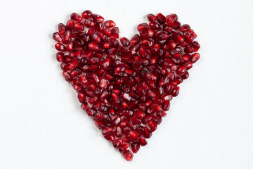 an elongated heart formed by pomegranate seeds