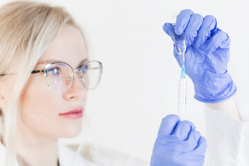 Fototapeta premium Hand holding syringe and vaccine.