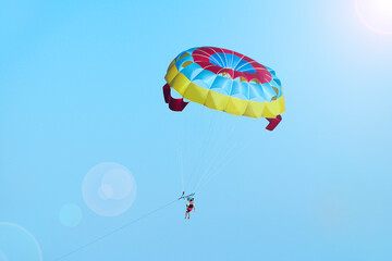 Man is fond of parasailing along sky. Free flying with parachute