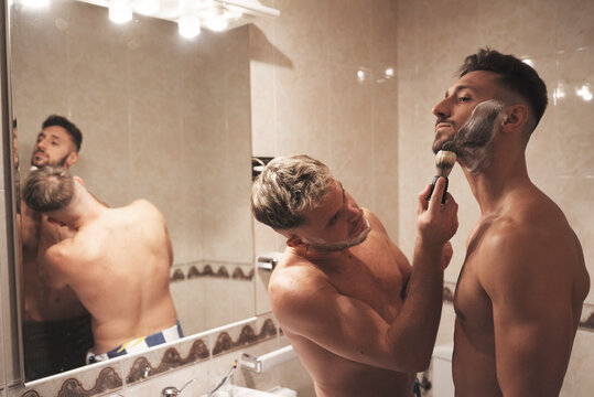 A boy helps his best friend shave