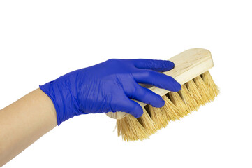 A hand in a blue rubber glove holds a cleaning brush isolated on white background. Selective focus.