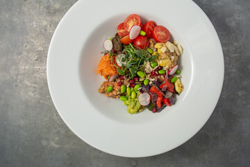 Mixed bean poke bowl salad with raddish, tomato, snap peas, green beans