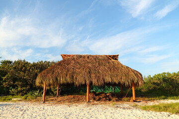 Rustic beach hut, hut or shelter built with palms on the shore, traditional Caribbean construction