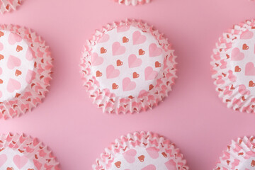 empty pink cupcake mold with hearts on a pink background. Valentine's Day