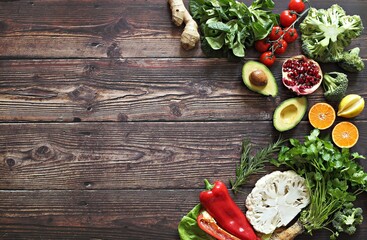 Healthy clean eating, plant based layout, vegetarian food and diet nutrition concept. Various fresh vegetables ingredients for cooking on dark wooden table background, top view, frame, banner