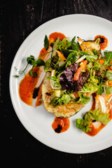 Couscous stuffed, baked aubergine topped with cheddar, served with a dressed baby leaf salad