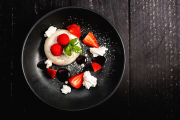 Vanilla Panna Cotta served with fresh Rutland strawberries, meringue shards and raspberry coulis