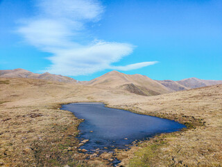 Small natural lake on a high mountain landscaping. Concept of hiking in the mountains, mountaineering, natural landscape. Balandrau mountain in Ripolles, Pirineus-Pyrenees Range, Catalunya, Spain.