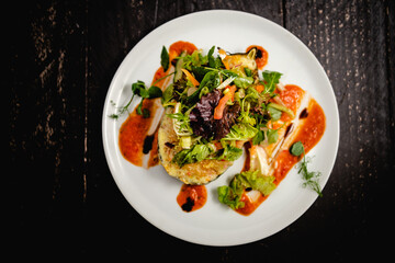 Couscous stuffed, baked aubergine topped with cheddar, served with a dressed baby leaf salad