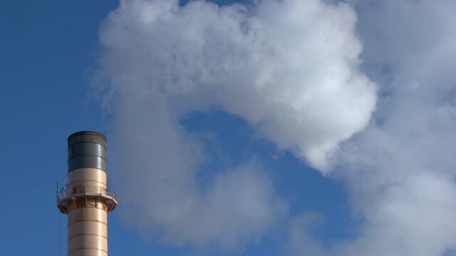 fluffy white smoke on factory industrial chimney heating coal power Plant blue sky air pollution mid shoot