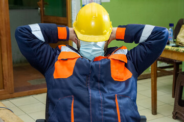 construction worker with yellow helmet and medical mask in factory, industrial worker with hard hat