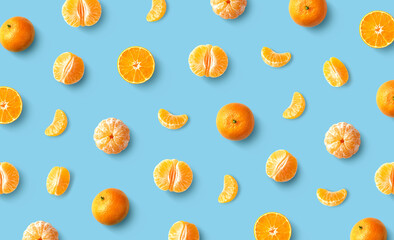 Colorful fruit pattern of fresh mandarin tangerine or clementine on blue background - Powered by Adobe