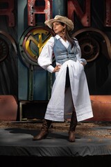 Obraz premium Beautiful Asian Indian woman in cowgirl themed fashion shoot.