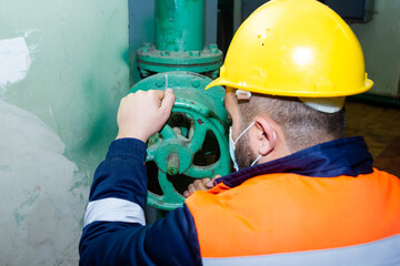 construction worker with yellow helmet and medical mask in factory, industrial worker with hard hat