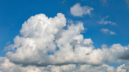 Naklejka na ściany i meble Beautiful blue sky with white clouds as a natural background.