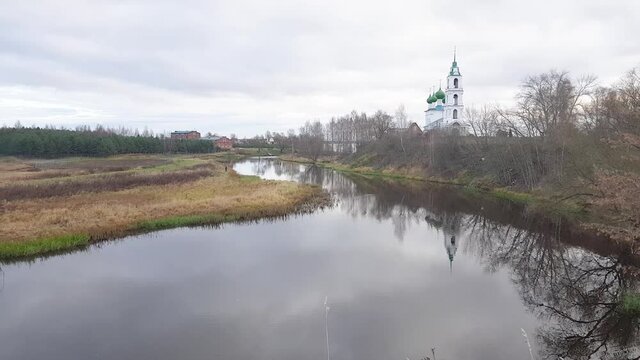 Holy Trinity Church in the village of Dievo Gorodishche, Yaroslavl region, Russia. Reflection of the Church and trees in the quiet backwater of tributary of Volga river.