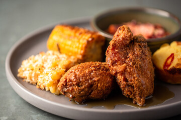 Southern fried chicken with mac and cheese, corn on the cob, coleslaw and maple syrup sauce