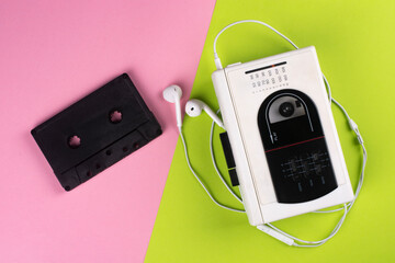 Vintage cassette player and audio cassette on a colored background. View from above. © Yevhenii