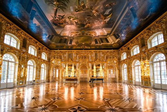 The ornate golden interior Great Hall with a grand piano inside the Rococo Catherine Palace at Pushkin near St. Petersburg, Russia taken on September 21 2019.