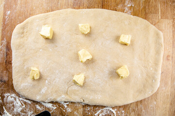 Raw cinnamon roll dough being prepared ready for baking